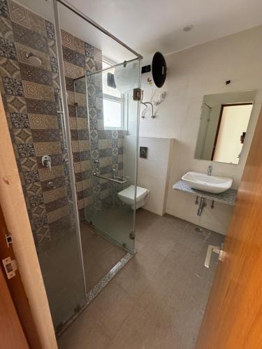 a bathroom with a shower and a toilet and a sink at Poonam apartments 2 in Prayagraj