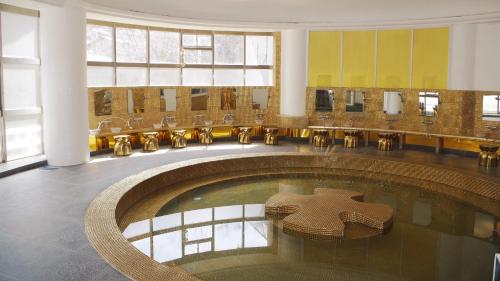 a large room with a pool of water in a building at ホテル　ロモサ in Minakami