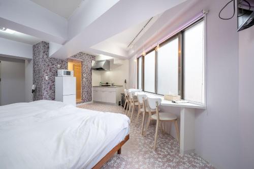 a bedroom with a bed and a table and chairs at Vacation Inn Omorikaigan 1 in Tokyo
