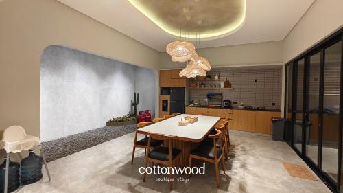 a kitchen and dining room with a table and chairs at Cottonwood Casarean Layar300inch Heated-Pool Billyard Api-Unggun in Tegalharendong