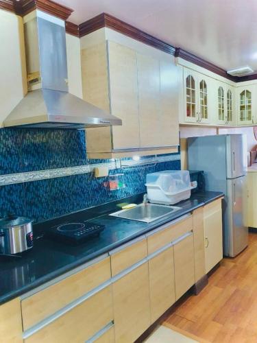 a kitchen with a sink and a counter top at Burnham Unit 504 Baguio Condo Transient by Dei Gratia in Baguio