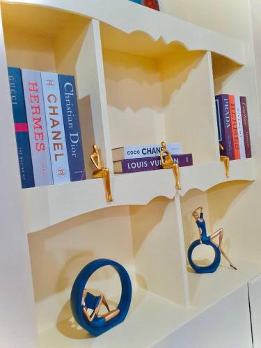 a book shelf with books and a toy person on a bike at Burnham Unit 504 Baguio Condo Transient by Dei Gratia in Baguio
