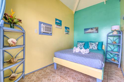 a bedroom with a bed and a shelf at Cosmic Crab Resort in Bocas del Toro