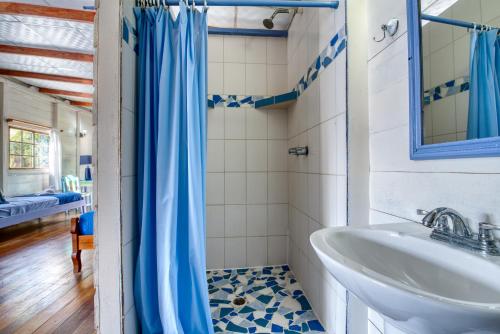 a bathroom with a sink and a mirror at Cosmic Crab Resort in Bocas del Toro