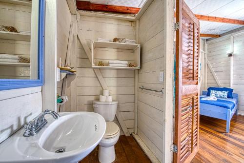a bathroom with a toilet and a sink at Cosmic Crab Resort in Bocas del Toro