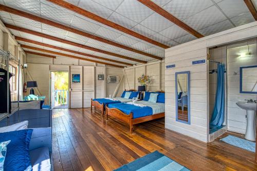 a bedroom with a bed and a sink at Cosmic Crab Resort in Bocas del Toro