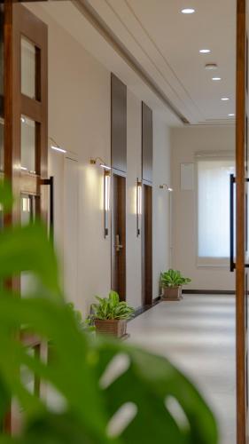 an empty hallway with potted plants in a building at Ishwar Kot in Sheoganj