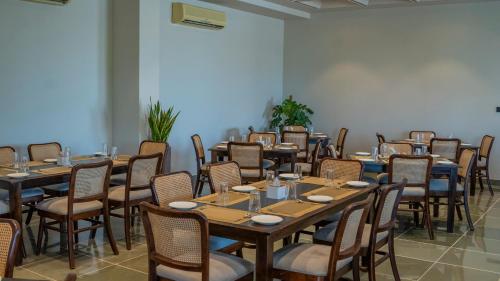 a group of tables and chairs in a room at Ishwar Kot in Sheoganj