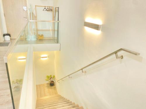 a staircase in a house with a glass railing at The Nordic - Icon City Petaling Jaya in Petaling Jaya