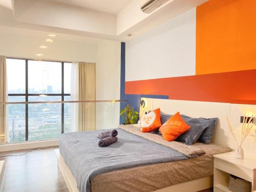 a bedroom with a bed with a teddy bear on it at The Nordic - Icon City Petaling Jaya in Petaling Jaya