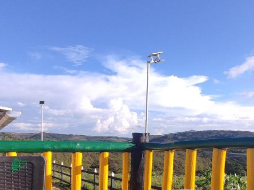 a yellow fence with a street light on top of it at Casa Guanentina - Habitaciones familiares in Villanueva