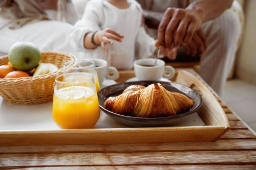 a tray with a breakfast of croissants and orange juice at Riviera Marriott Hotel La Porte De Monaco in Cap d'Ail