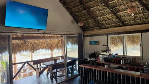 a living room with a large flat screen tv on the ceiling at EcoPalapa Mimí in Tuxpan de Rodríguez Cano
