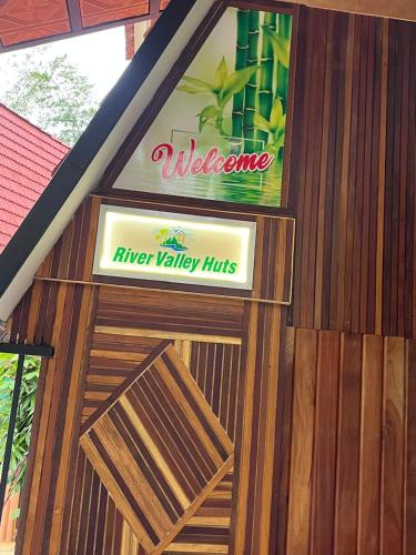 a sign on the side of a building at River Valley Huts, Wayanad in Panamaram