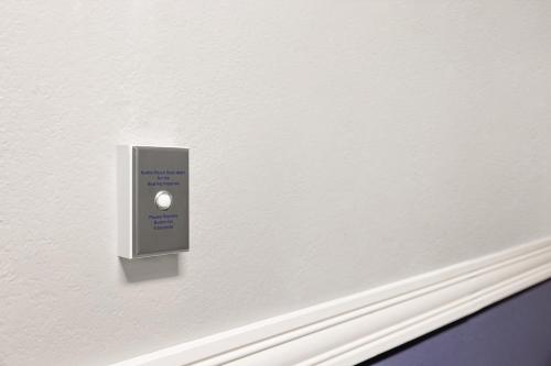 a lightswitch on a wall in a room at AmericInn by Wyndham Madison WI in Madison