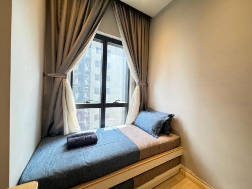 a bed in a room with a large window at The Caspian - Icon City Petaling Jaya in Petaling Jaya