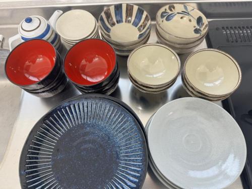 a bunch of plates and bowls sitting on a table at 海野Sea Terrace in Nanjo