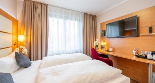 Ένα ή περισσότερα κρεβάτια σε δωμάτιο στο PLAZA INN Braunschweig City Süd