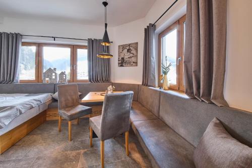 a bedroom with a bed and a table and chairs at Appartements Der Fuchsbau in Saalbach Hinterglemm