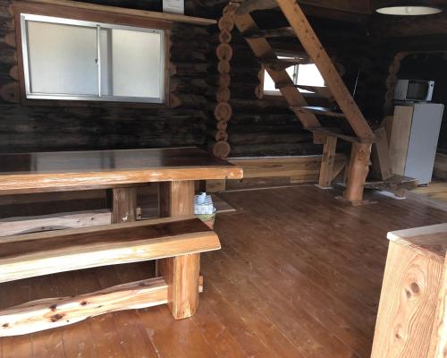 a room with a wooden table and a window at 民泊ログ in Goto