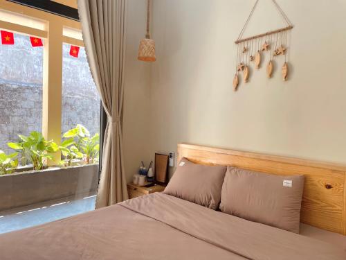 Ένα ή περισσότερα κρεβάτια σε δωμάτιο στο Homestay Nhà Trong Hẻm Đảo Phú Quý