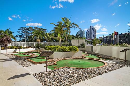 a miniature golf course in a resort with palm trees at Ocean Tower Unit 1104 - Twin Towns in Tweed Heads
