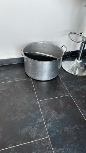 a metal pot sitting on the floor in a kitchen at XDfinca in Palermo