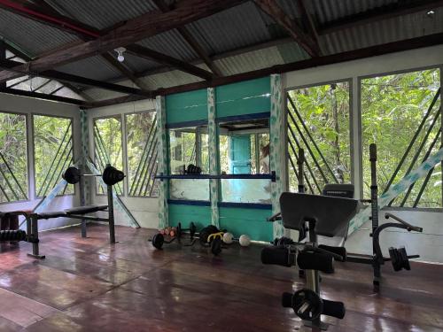 a gym with a mirror and a chair in a room at Finca Tatin Hotel in Lámpara