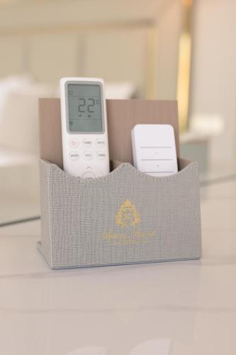 a box with an ipod and a remote control at Privilege Suite by Apsara Resort in Koh Rong Island
