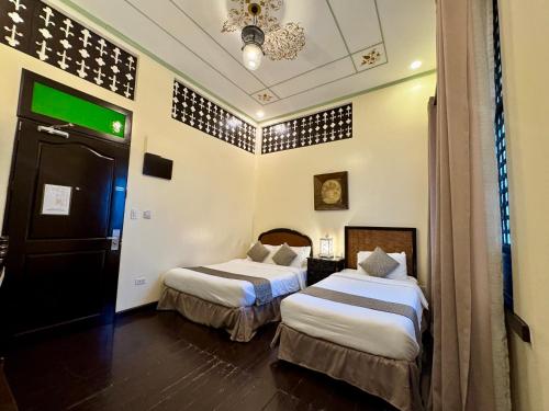 a hotel room with two beds in a room at Park Avenue Boutique Hotel Manila in Manila