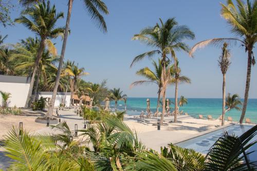 a view of a beach with palm trees and the ocean at Privilege Suite by Apsara Resort in Koh Rong Island