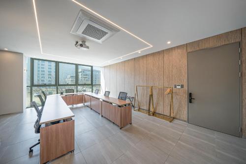 an office with desks and a tv on the ceiling at Act Hotel in Daegu