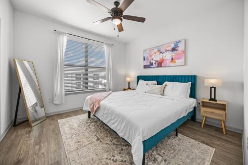 a bedroom with a bed and a ceiling fan at Charming Frisco Apt with Pool & Gym in Frisco