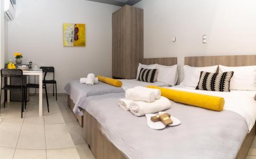 two beds in a room with towels on them at Xenia_Apartments A7 in Kozani