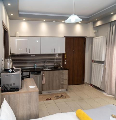 a kitchen with white cabinets and a counter top at Xenia_Apartments A7 in Kozani
