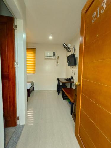 a room with a hallway with a table and a desk at Delle Suites in General Santos