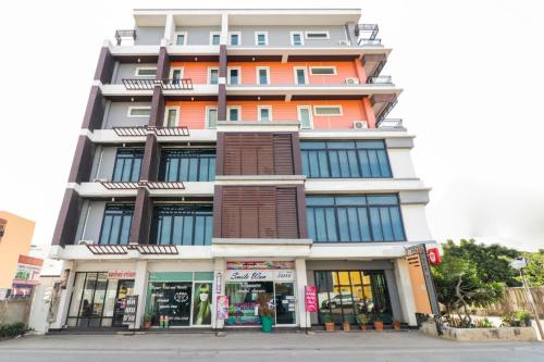 an orange and white building on a city street at King One Suvarnabhumi in Bangkok