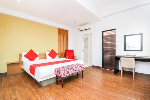 a hotel room with a bed and a desk at King One Suvarnabhumi in Bangkok