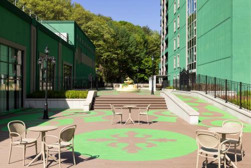 a courtyard with tables and chairs in a building at Sono Calm VivaldiPark in Hongcheon