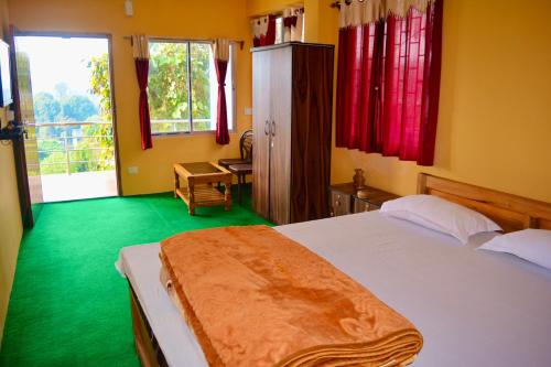 a bedroom with a bed and a green floor at Golden Sunview Homestay in Mirik