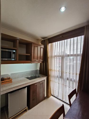 a small kitchen with a sink and a window at Delle Suites in General Santos