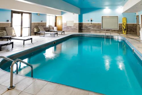 a large pool with blue water in a hotel room at Wingate by Wyndham Owensboro in Owensboro