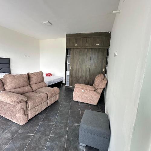 a living room with a couch and two chairs at XDfinca in Palermo