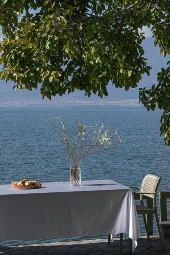 a table with a vase on it next to the water at Yang Liping Xianguo'an Moon Palace Villa, Shuanglang, Dali in Dali Shuanglang