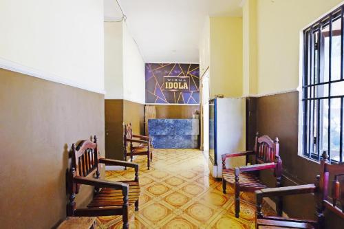 a room with chairs and a sign in a building at OYO 75539 Phanthida Resort and Cafe in Hua Hin