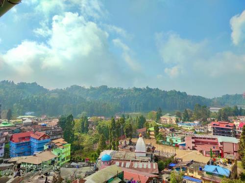 a view of a city with buildings and trees at Golden Sunview Homestay in Mirik