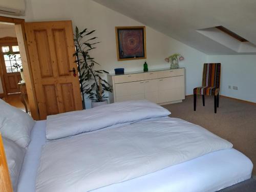 a bedroom with a white bed in a room at Ferienwohnung Spittler in Cham