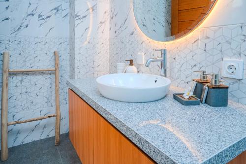 a bathroom with a large white sink on a counter at Cozy 2BR Villa May II near Pererenan Beach in Cemagi