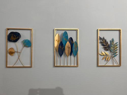 a group of four pictures of surfboards on a wall at Urban Escape in Silchar