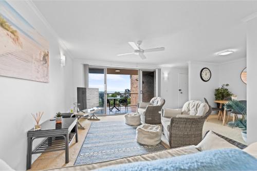 a living room with a couch and chairs at Seaside Holiday Apartments Tugun in Gold Coast